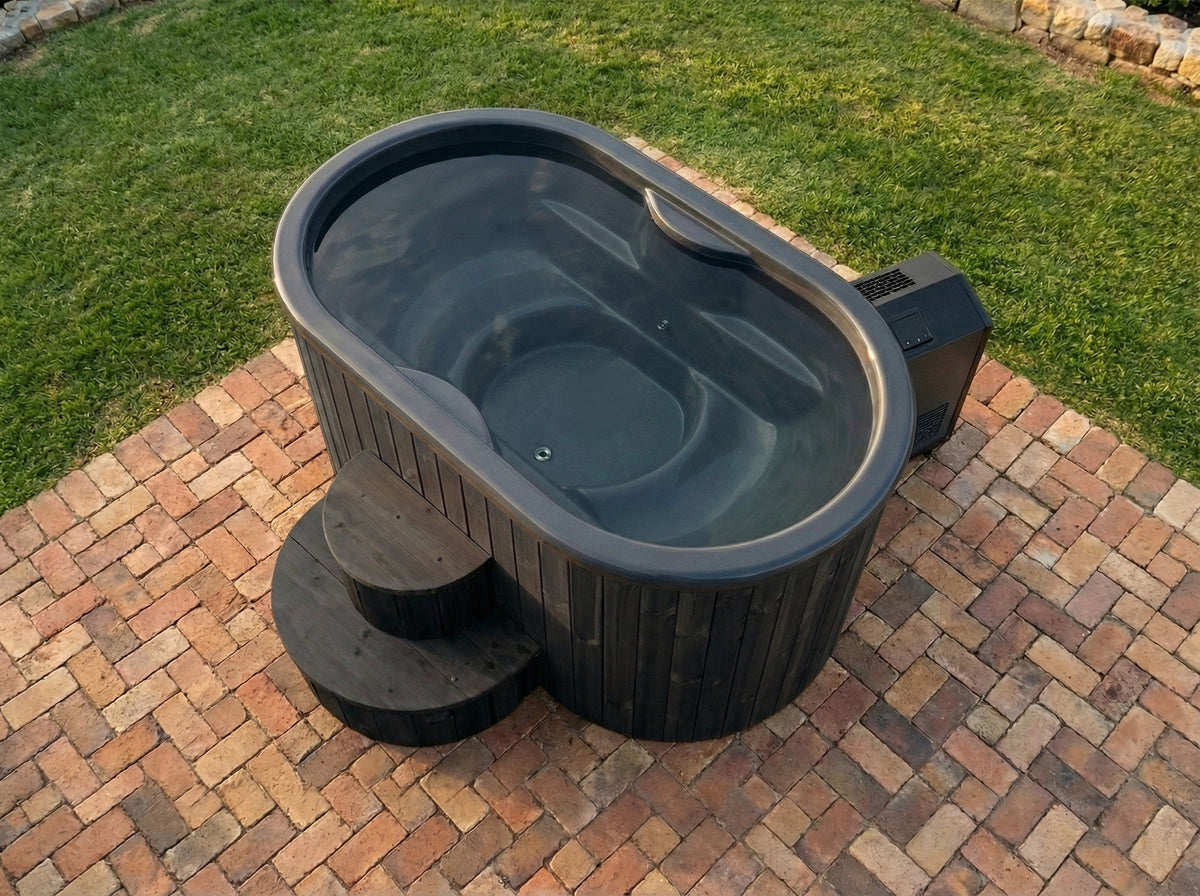 SaunaLife two-person immersion tub, black finish, on a brick patio