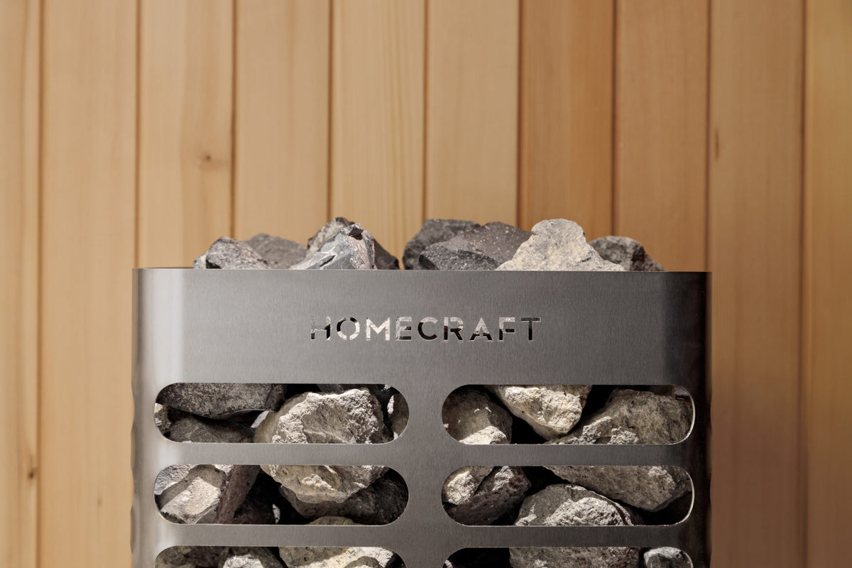 Homecraft Revive sauna heater against cedar with stones visible through the louvres