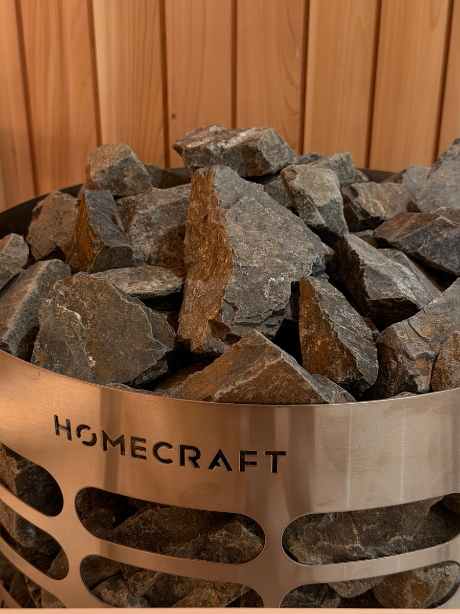 Homecraft heater loaded with sauna stones against cedar walls