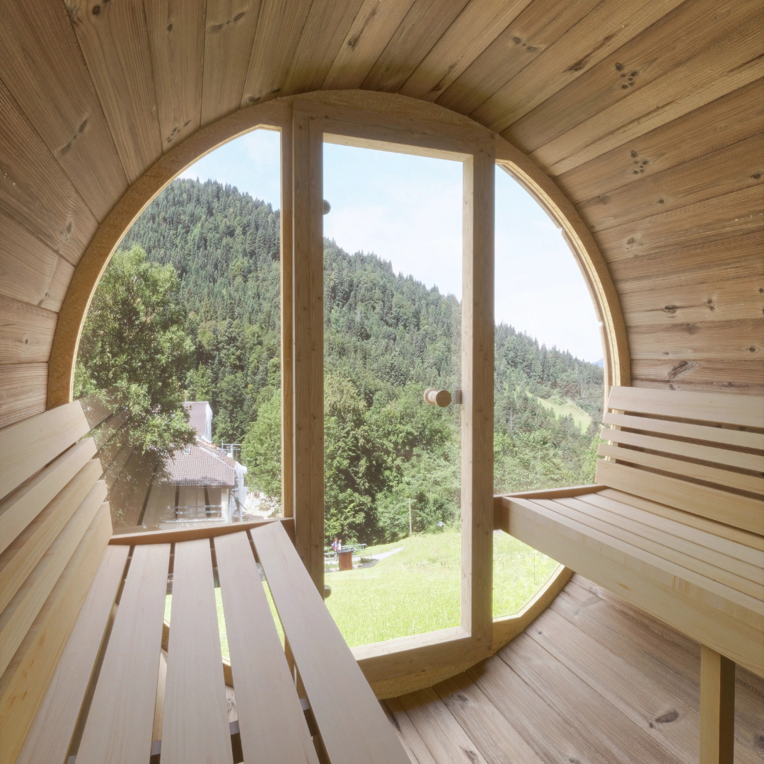 SaunaLife Model E7G, 4-person barrel sauna with panoramic glass, angled view