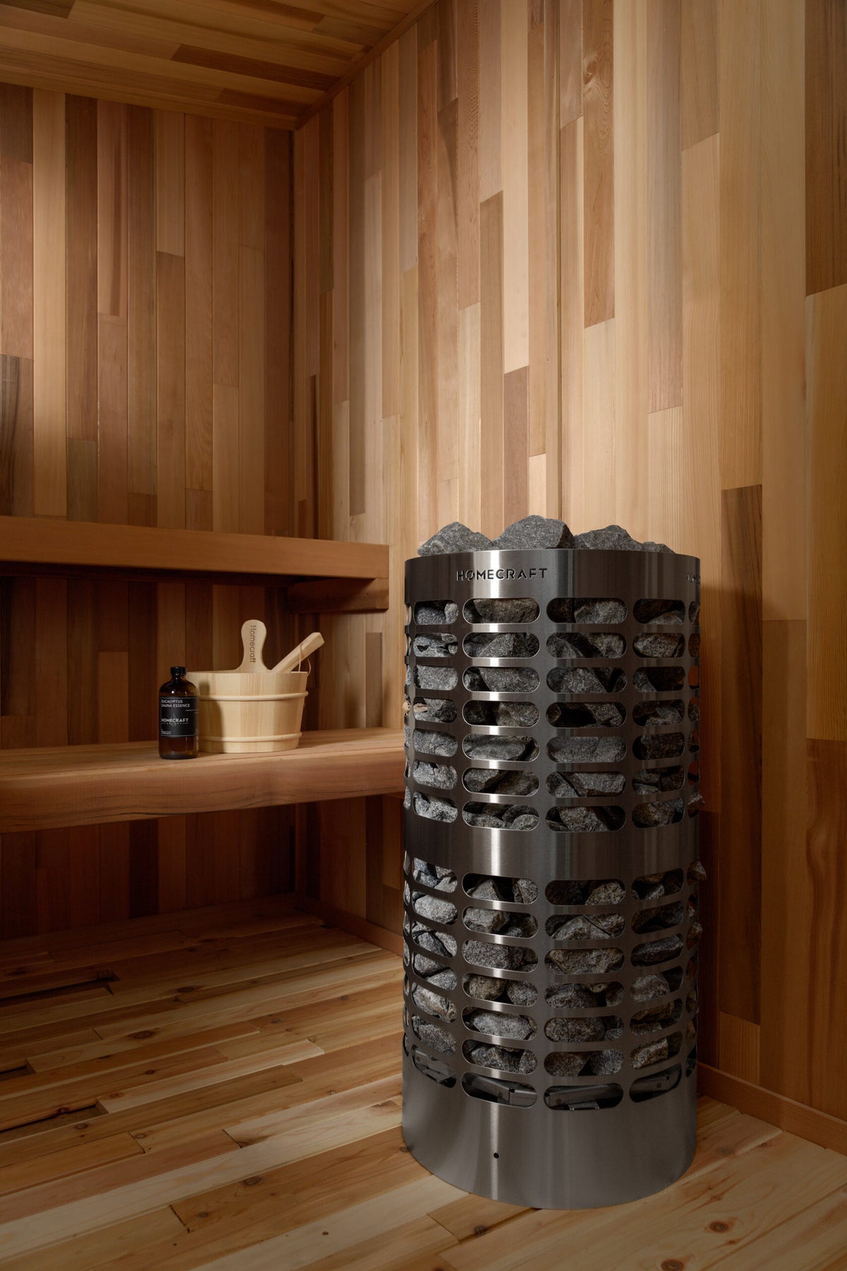Homecraft Apex sauna heater in a cedar corner with benches and a wall light
