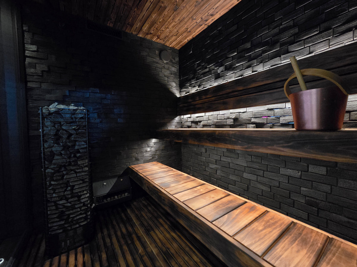 Stone, glass and black-painted thermally modified wood