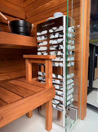 Homecraft Revive Slim heater in a cedar sauna beside a glass wall